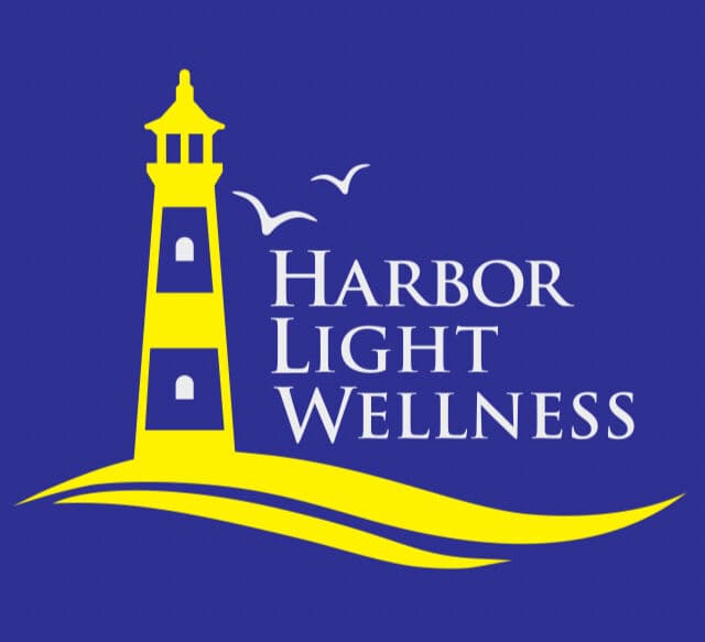 The original Harbor Light Wellness logo, a yellow lighthouse with gulls on royal blue